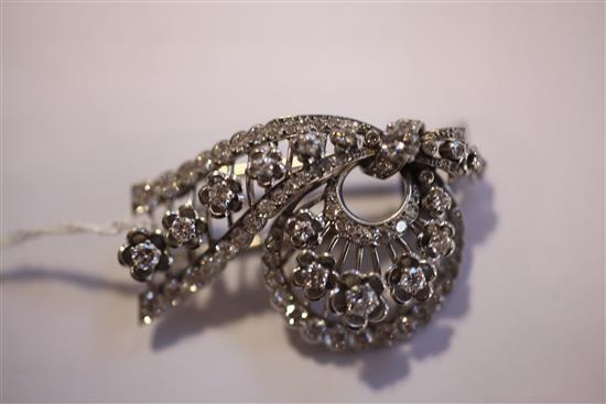 A 1950s Cartier platinum and diamond clip brooch, approx. 2in.